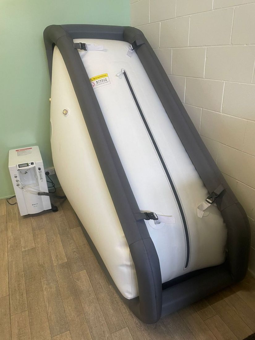 The 1.5 ATA hyperbaric chamber at Free Spirit in Papakura, with its oxygen concentrator alongside